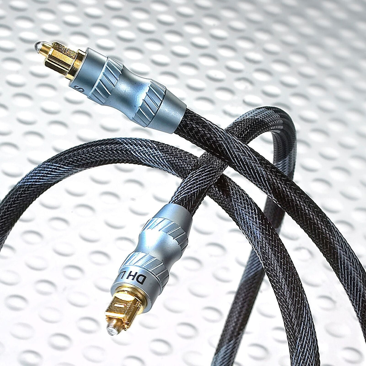 Optical Toslink cable with black braided jacket and gold-plated connectors, coiled loop