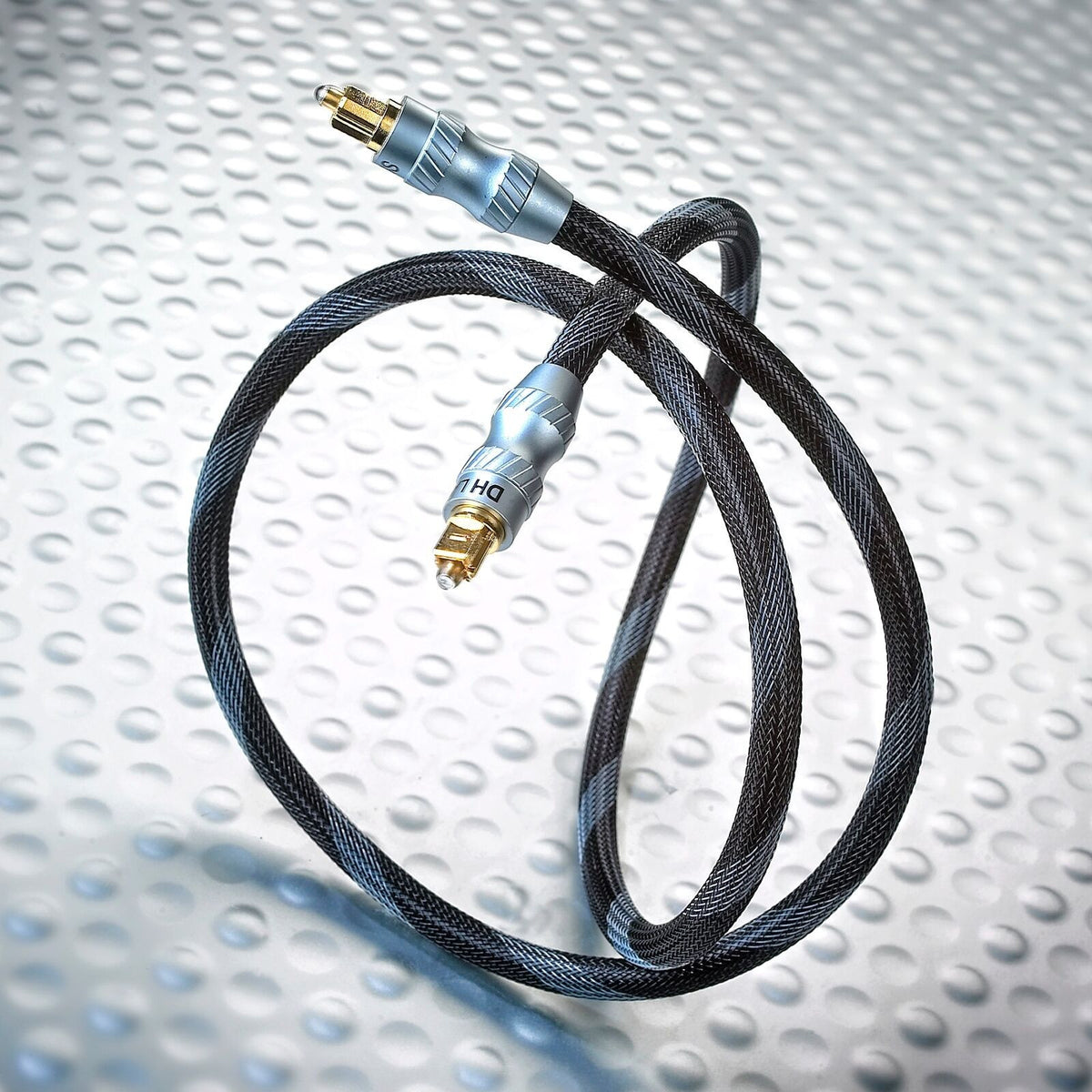 Optical Toslink cable with black braided jacket and gold connectors, straight view