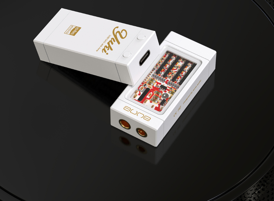 White portable DAC/headphone amp with exposed circuit board panel and gold ports
