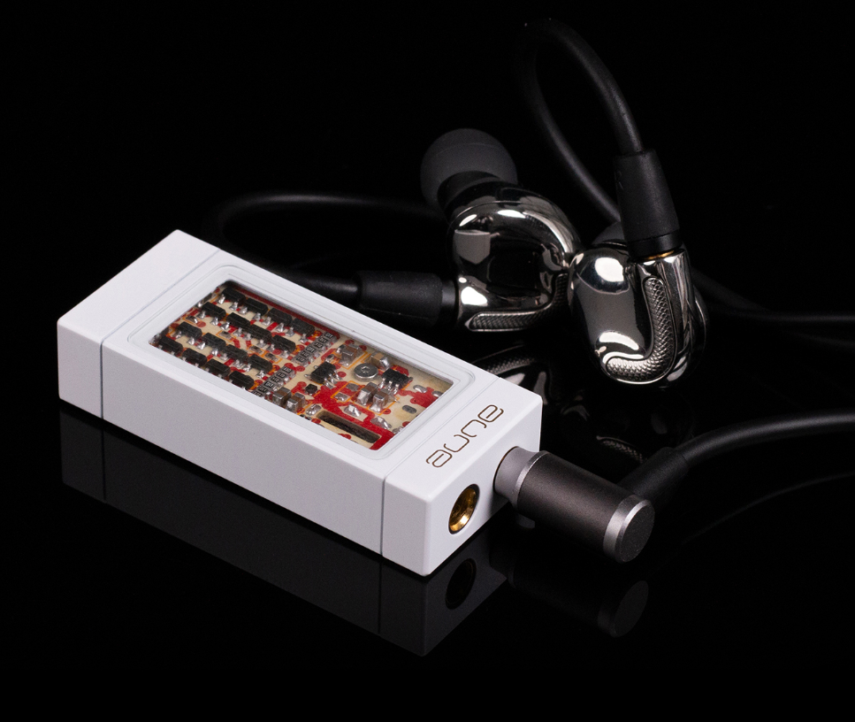 White portable DAC/headphone amp with circuit board window and connected headphone cable