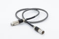 Silver braided digital audio cable with metal connectors and black cable segment
