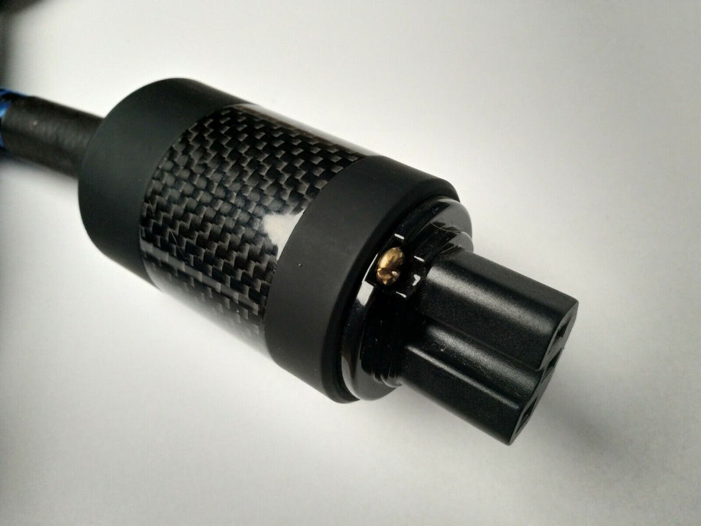 Black carbon-fiber IEC plug with gold contact pin and textured grip ring