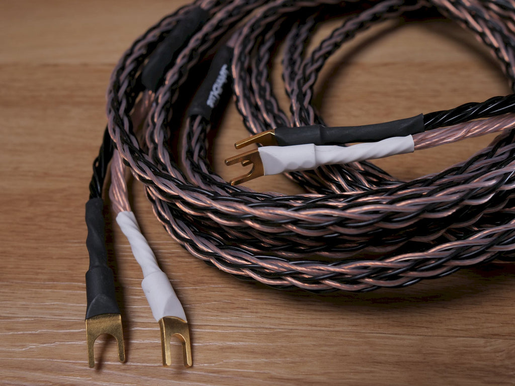 Speaker cable bundle with gold banana connectors and black jacket insulation