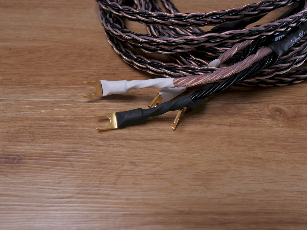 Speaker cable ends with gold banana connectors, black and white insulated tips