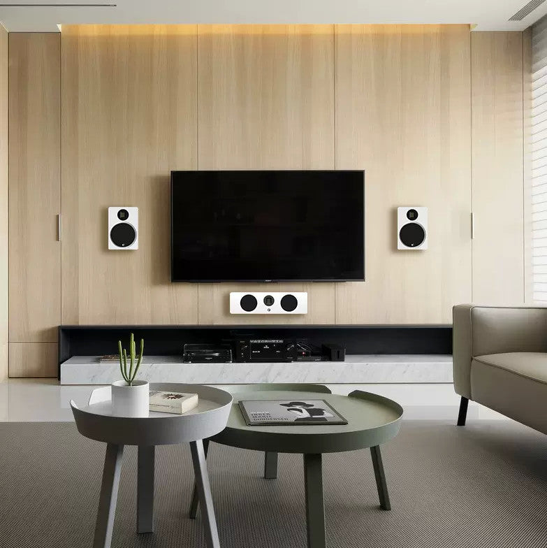 Black wall-mounted charging panel beside flat-screen TV, with circular power area