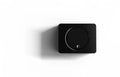 Black wall control panel with circular knob and small logo