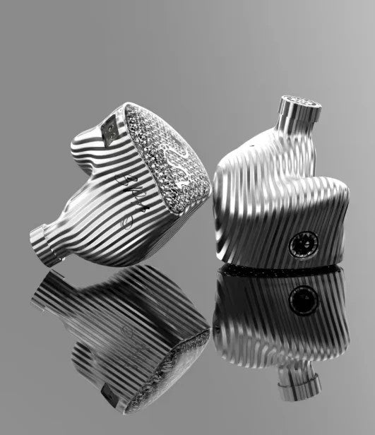 Pair of silver in-ear monitors with ribbed chrome accents and mesh speaker shells