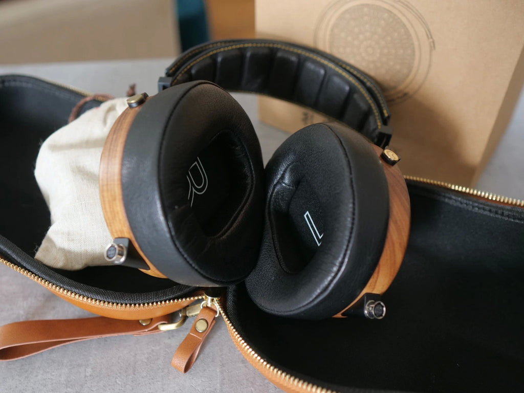 Black over-ear headphones with wooden rings and circular ear cushions