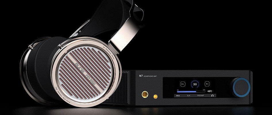 Black over-ear headphones with silver grille and headphone DAC amp unit