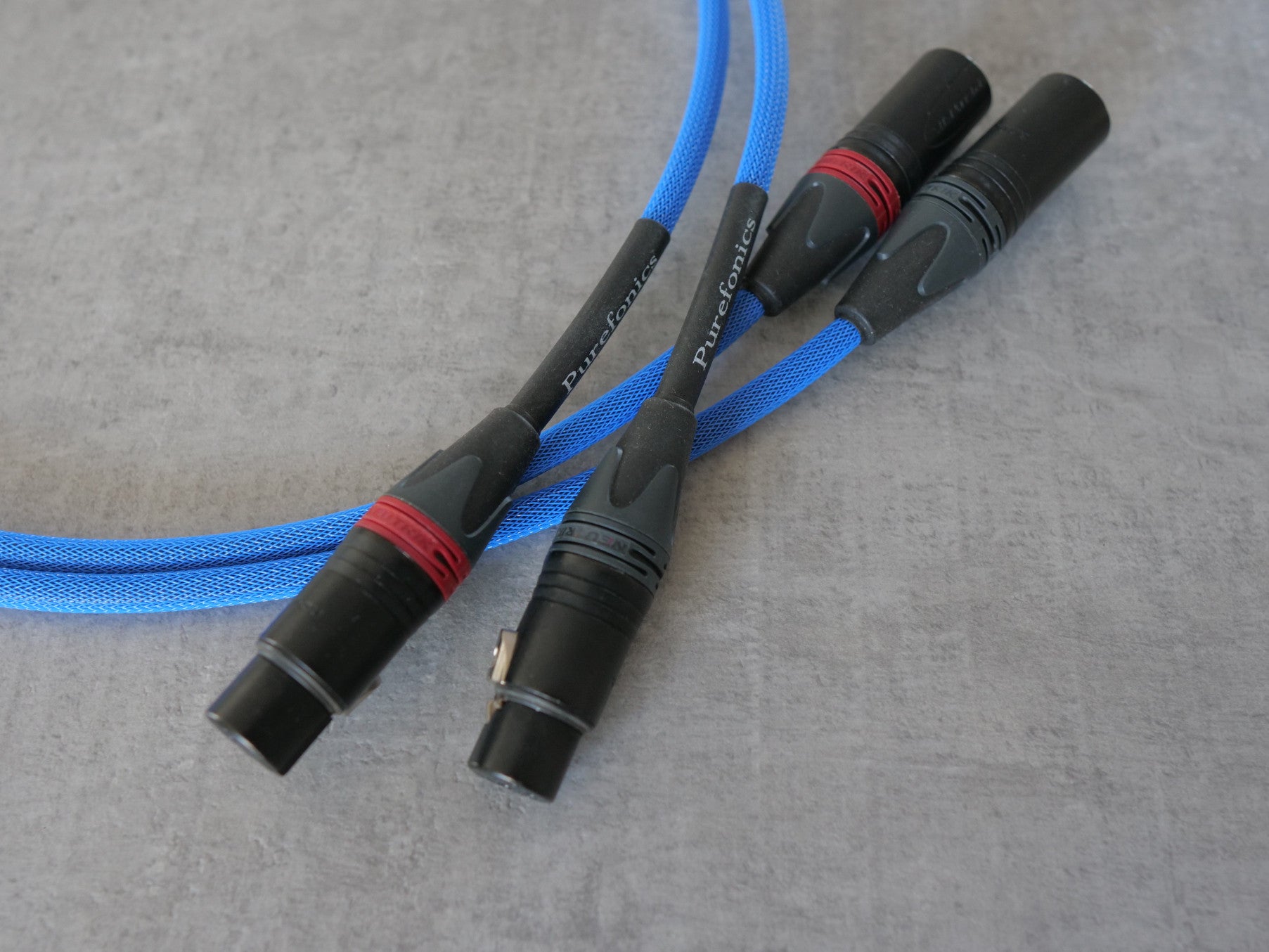 Blue XLR audio cable with multiple black connectors and red accents at cable tips