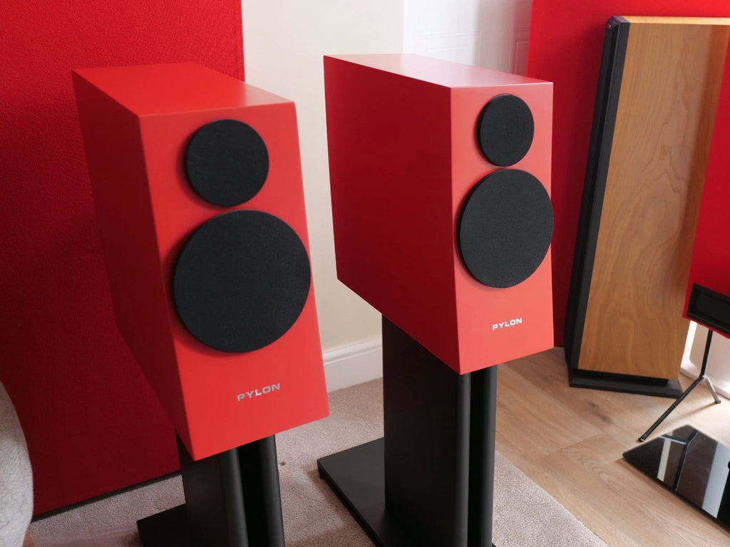 Pair of red speakers with two black drivers each on black floor stands