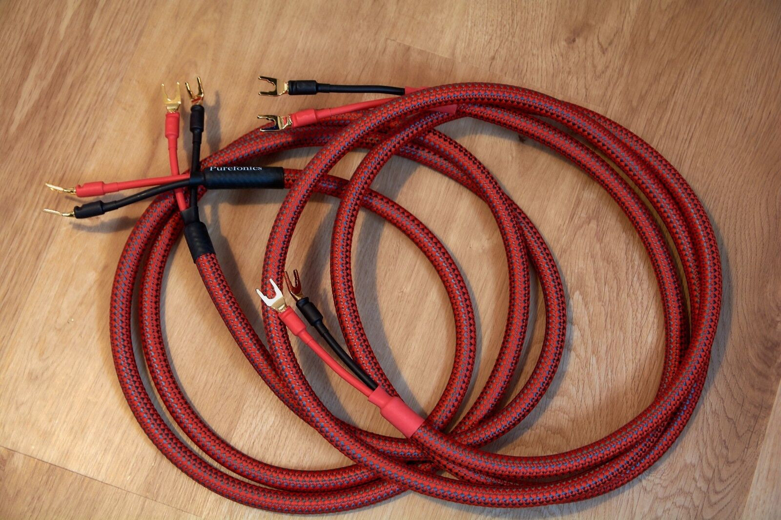 Red braided audio cable set with multiple gold banana plugs and black connector ends