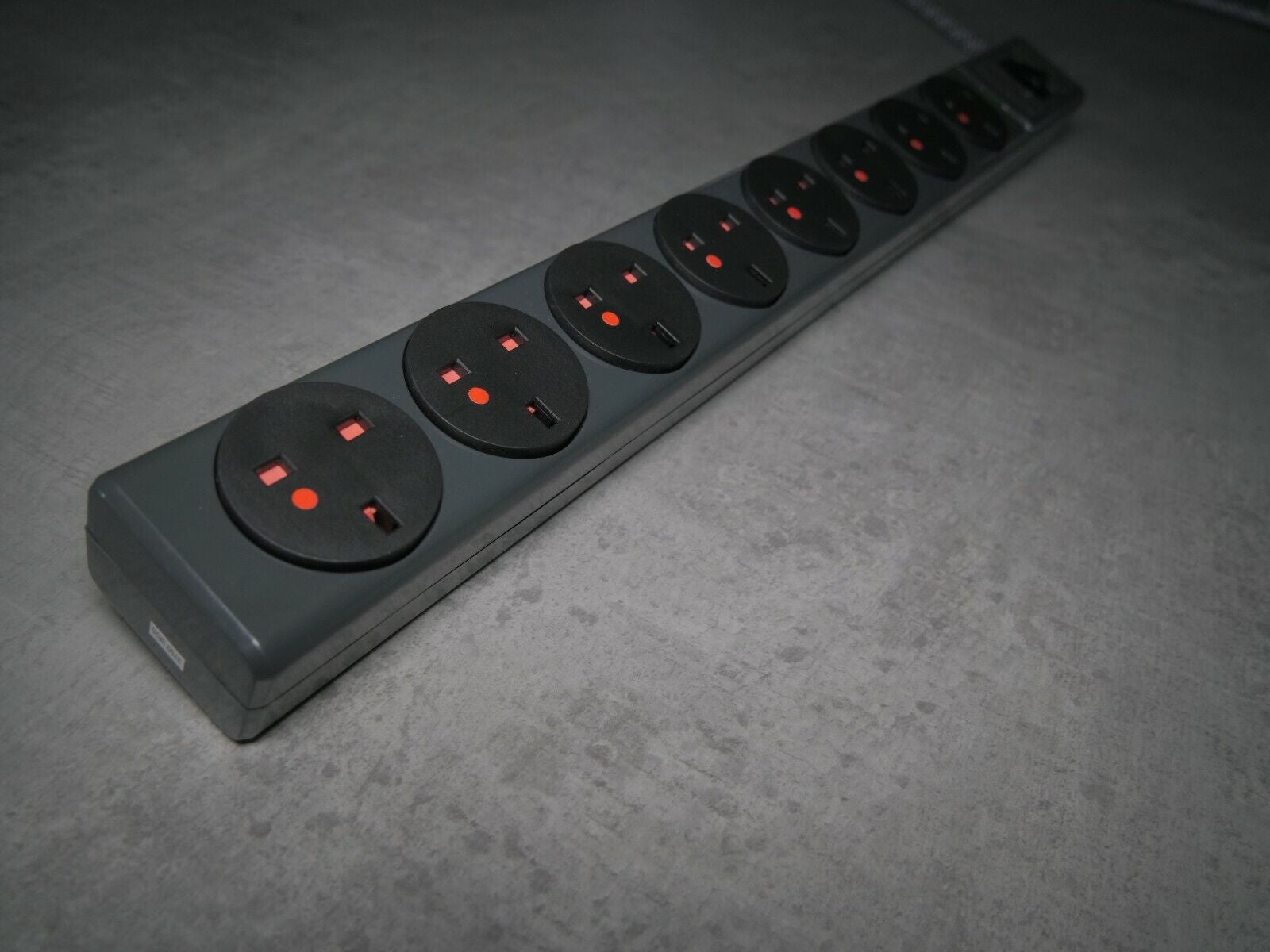 8-outlet power strip with multiple round sockets and red indicator lights
