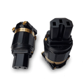 Black power plug adapter with gold-toned pins and connector caps