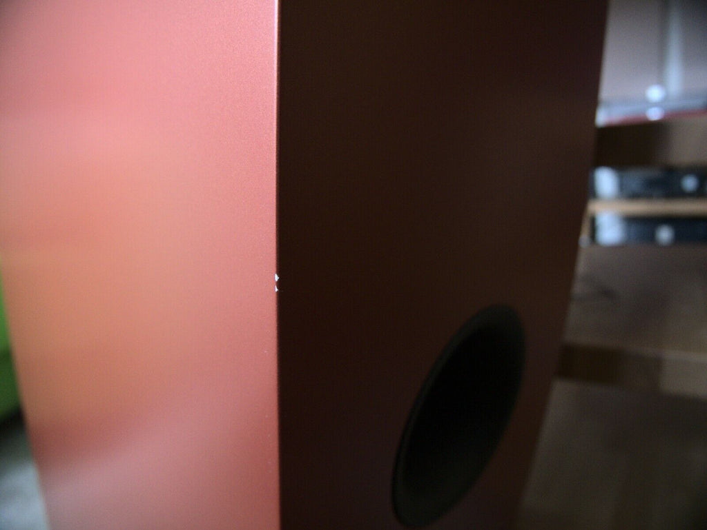 Orange speaker cabinet with visible circular midrange driver