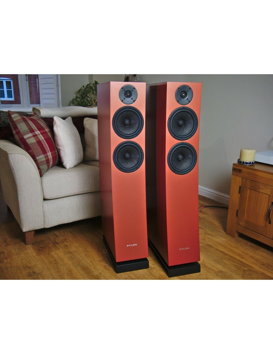 Orange bookshelf speaker tower with three black drivers and front tweeter