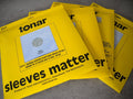 Yellow record sleeves with large "sleeves matter" text and Tonar logo