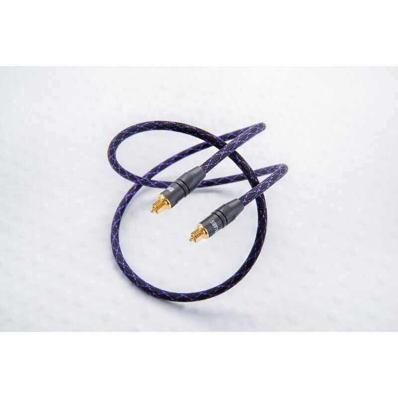 Purple braided audio cable with two gold RCA plugs, cable looped in a U shape