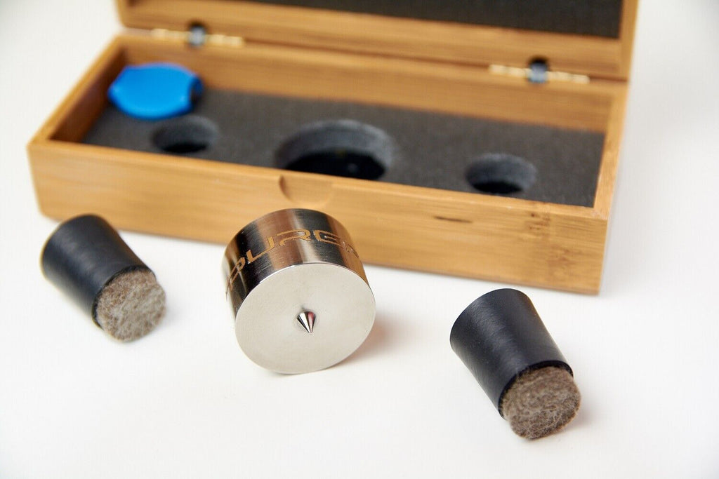 Open wooden case with metal roller, blue cap, and three dark felt cylinders