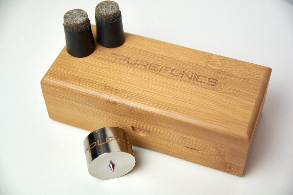 Bamboo sound device with engraved logo, metal roller, and two dark felt cylinders