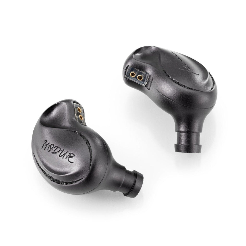 Kinera Hodur black in-ear monitors, close side view with gold driver port openings