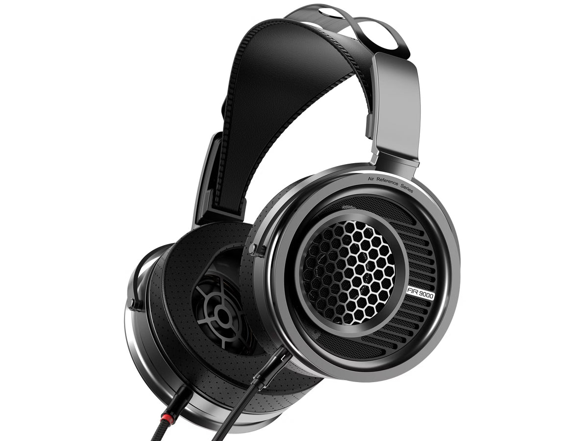 A pair of over-ear aune ar9000 wired headphones with a black and silver metallic finish, featuring a honeycomb grille on the ear cup, shown against a plain white background.