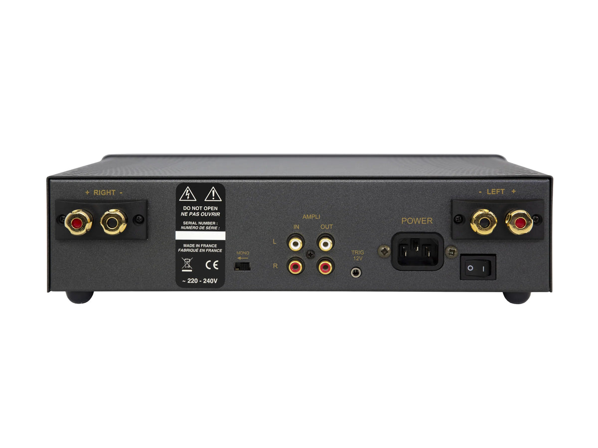 Rear panel of a black audio amplifier or receiver, showing left and right speaker terminals, input and output jacks, power socket, and warning labels on a white background.