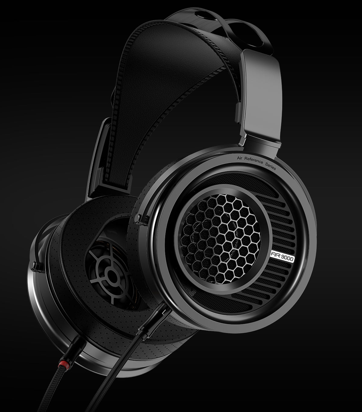 A pair of black aune ar9000 over-ear headphones with a honeycomb grille pattern on the ear cup, shown against a dark studio background.