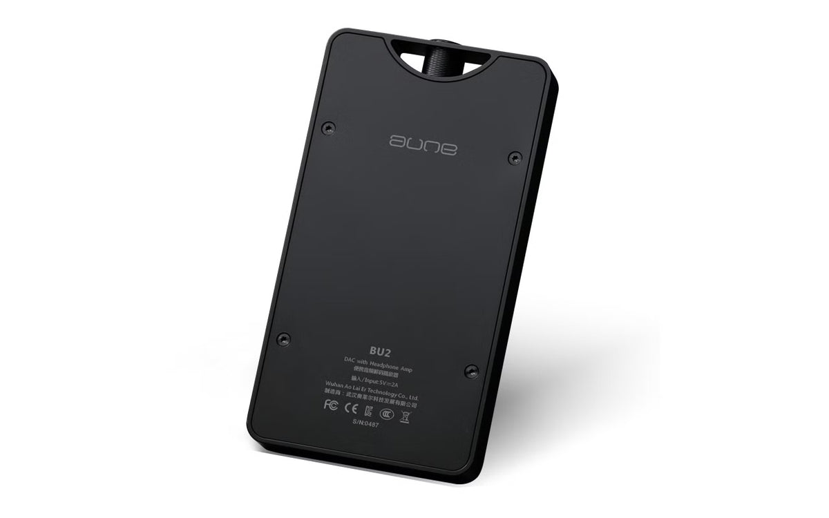 The back of a blackaune portable headphone amplifier , showing the matte finish, screw holes, and regulatory markings on a clean white background.
