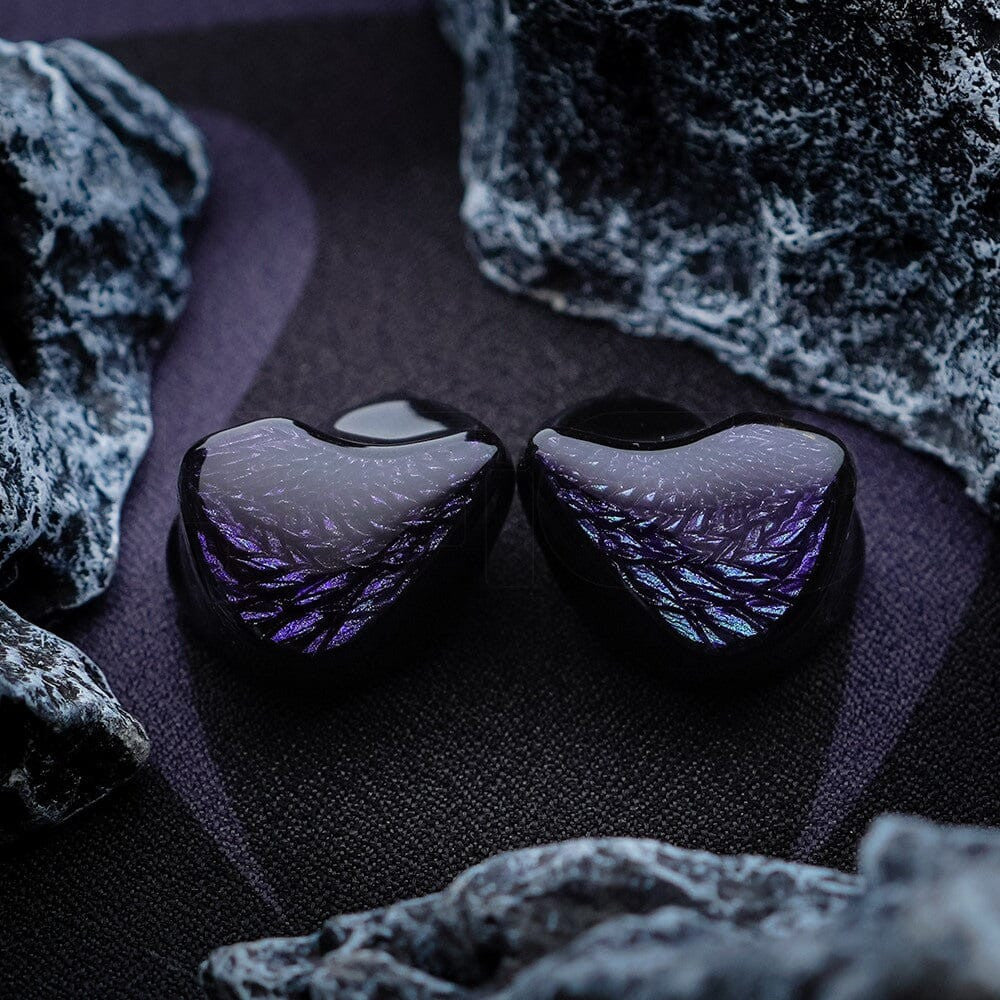 Pair of black in-ear earphones with purple iridescent textured shells