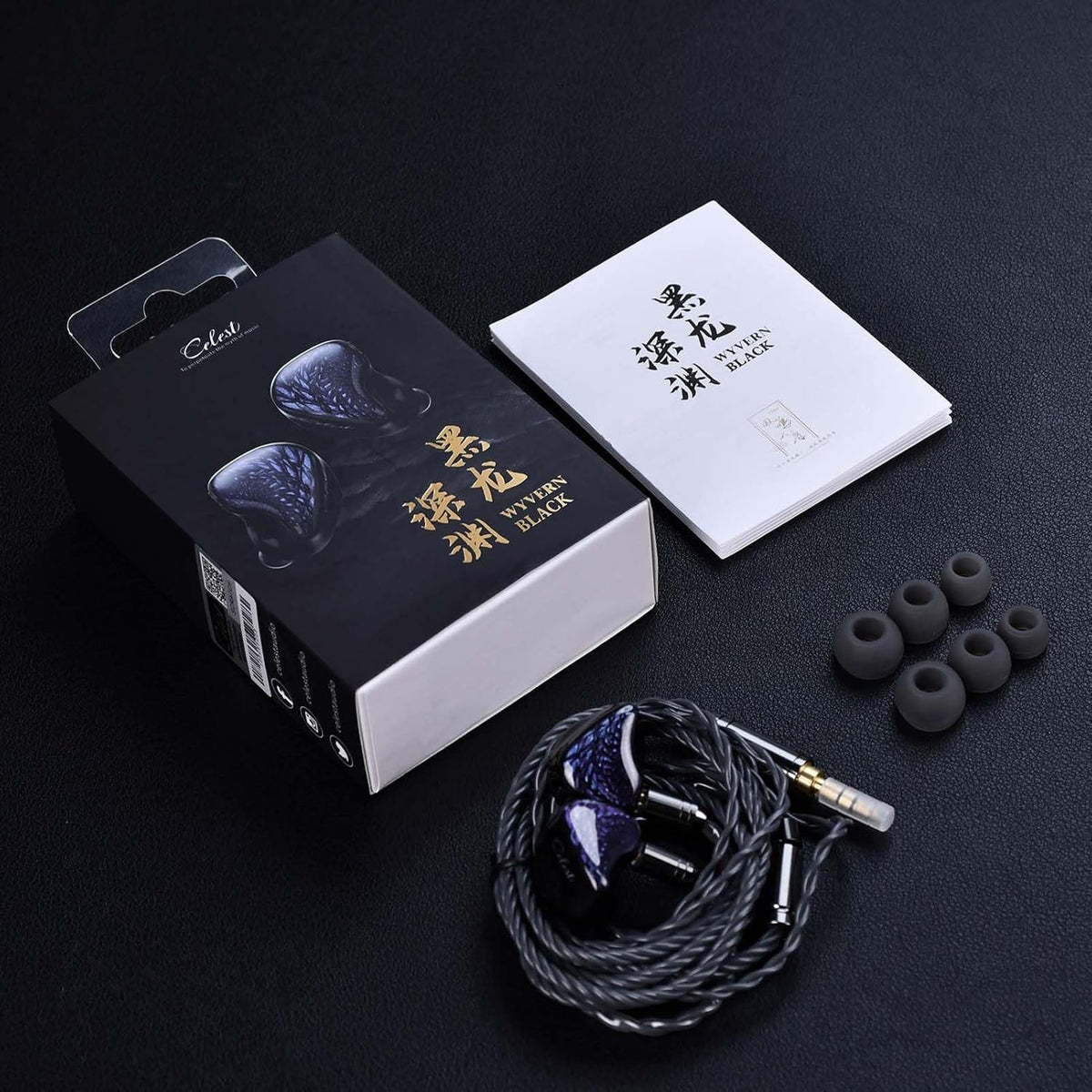 Black earphones with purple iridescent faceplates, box contents and cable tips