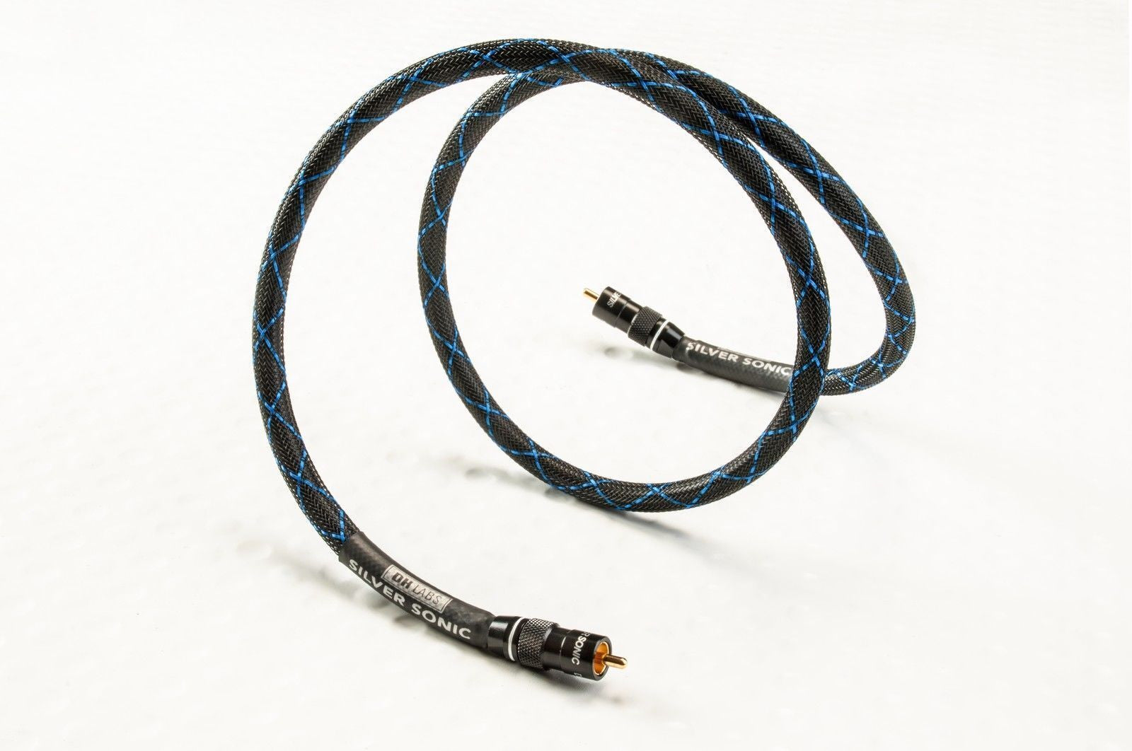 Silver Sonic braided audio cable with blue stitching, featuring a black outer jacket and gold-plated connectors, coiled on a white background.