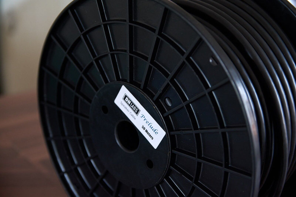 DH-Labs Prelude cable reel, black spool hub with white label.