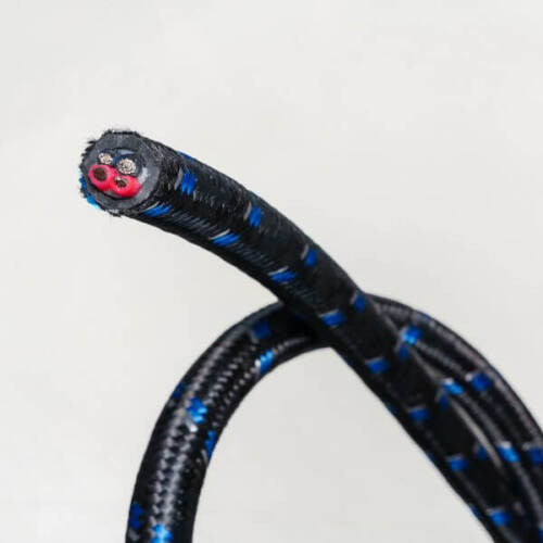 Black speaker cable braid with blue stripes and red circular connector at end