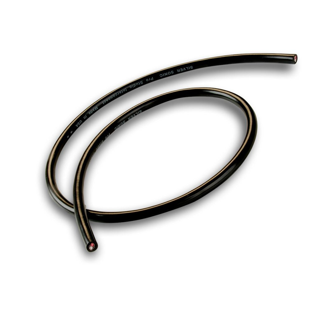 Black analogue audio interconnect cable loop with printed markings and red-tipped end