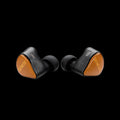 A pair of black in-ear wireless earbuds with textured orange end caps featuring the brand name 'GENESHY' in gold lettering, shown against a solid black background.