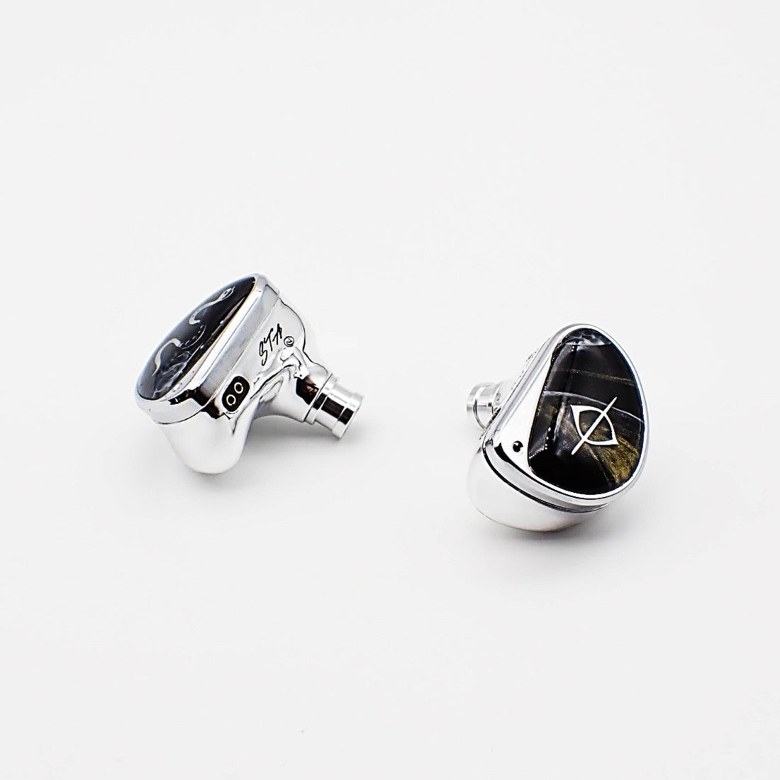 Two silver in-ear monitors shown from different angles on a clean white background, featuring black oval stone inlays with white geometric symbols.