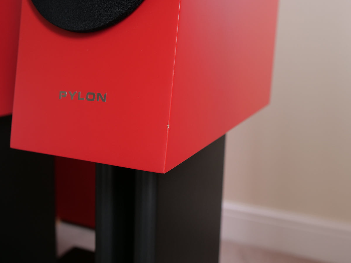 Red speaker cabinet front with PYLON text and black stand legs