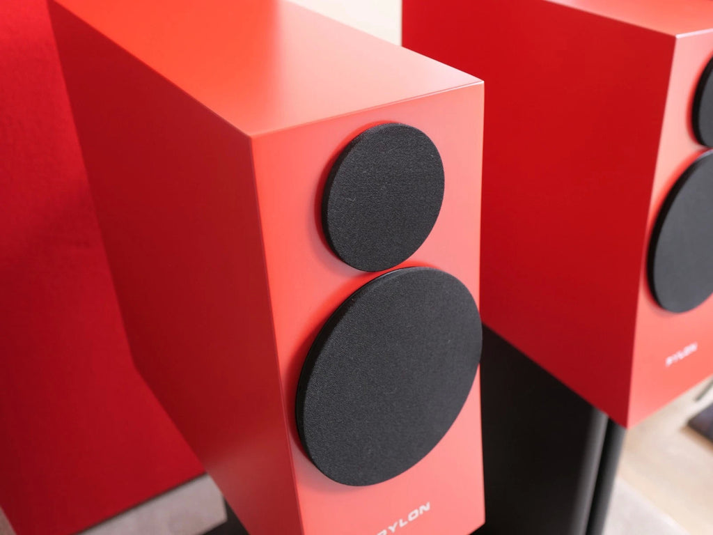 Close-up of two black speaker drivers on a red cabinet with PYLON logo