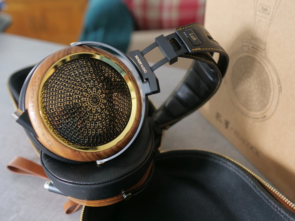 Sendy Audio peacock headphones Black over-ear headphones showing gold center speaker grille and leather trim