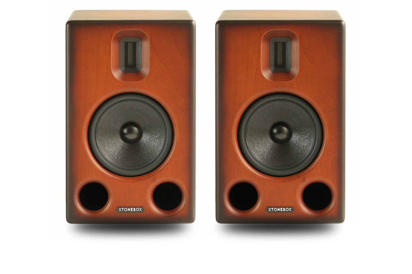 Two xtonebox studio monitor speakers with a warm reddish-brown wood-grain finish and black drivers, shown side-by-side on a white background.