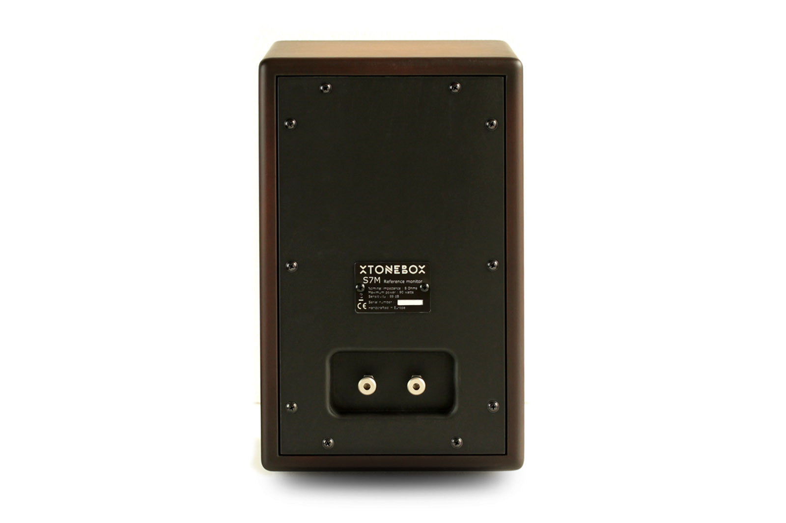 The rear view of a XTONEBOX S-7M speaker cabinet, featuring a dark brown wood-grain finish and a black metal backplate with mounting screws and terminal connectors, on a white background.