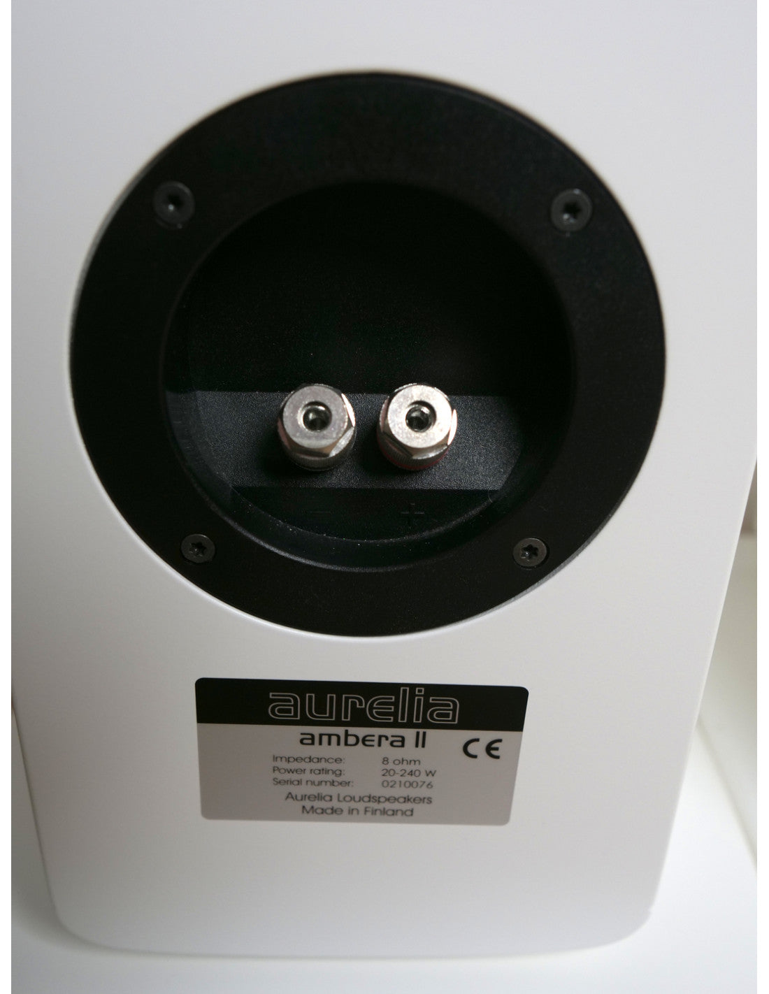Close-up of the rear mounting plate of an Aurelia Ambera II speaker, showing the two terminal connectors and the product label.