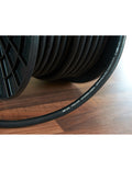 Black coiled speaker cable with printed DH Labs Prelude along the jacket