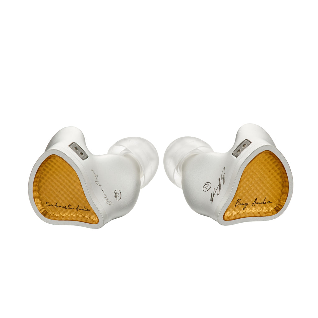 A pair of high-end in-ear monitors by earacoustic Audio, featuring a white outer shell, clear silicone ear tips, and a textured gold inner headband rest, shown against a solid white background.