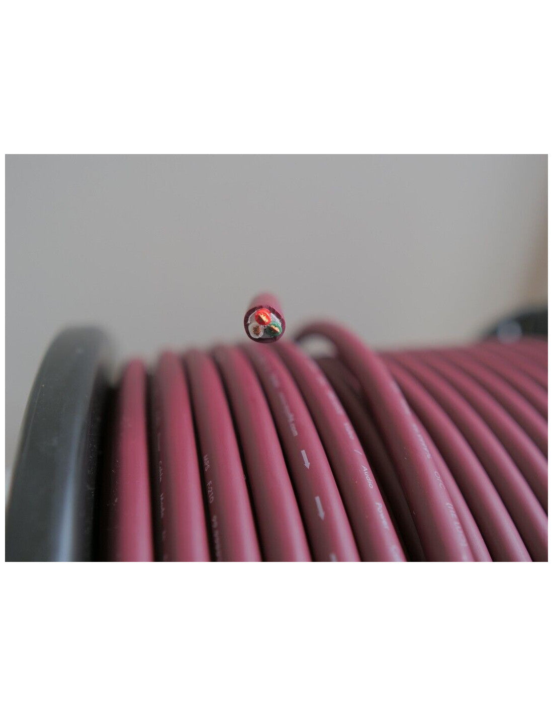 Maroon power cable coil with exposed wire ends at the top loop