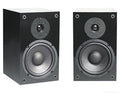 Two black NHT superones bookshelf speakers with silver-gray drivers, shown side by side against a plain white background.