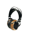 Over-ear headphones with wood-pattern ear cups and black mesh grille, angled view
