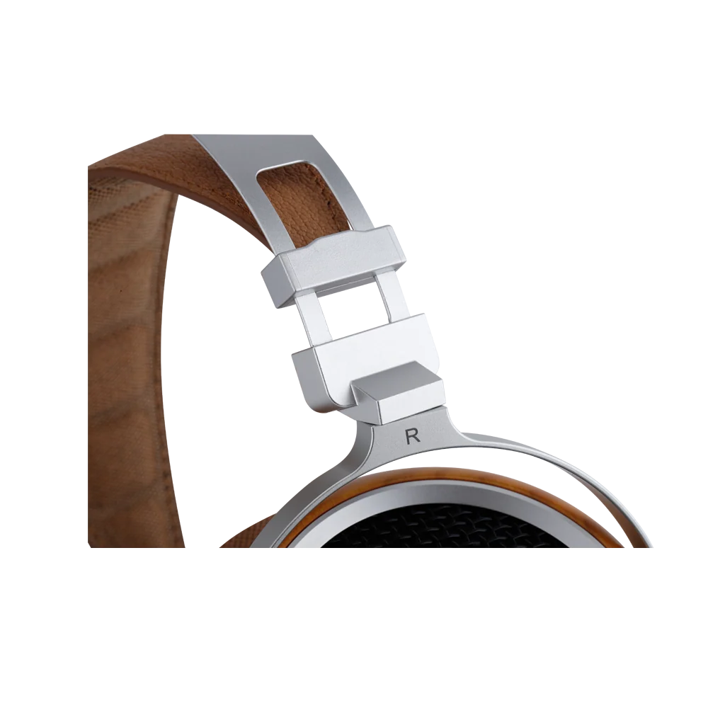 Close-up of an over-ear headphone headband hinge and earcup showing a silver metal clasp, brown leather headband, and wood-toned earcup on a white background.